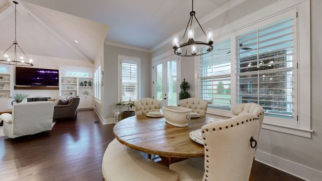 This cozy dining nook flows seamlessly into the living room, featuring warm natural light, plantation shutters, and elegant finishes—perfect for casual meals or morning coffee with a view. | Image 21