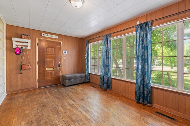 Empty room featuring wood-type flooring, wood walls, and baseboards | Image 20