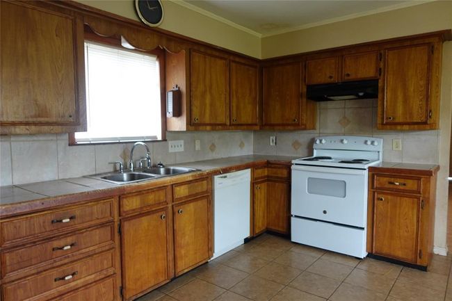 Spacious kitchen with ample cabinet storage. | Image 31