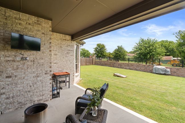 Fenced backyard with a patio | Image 35