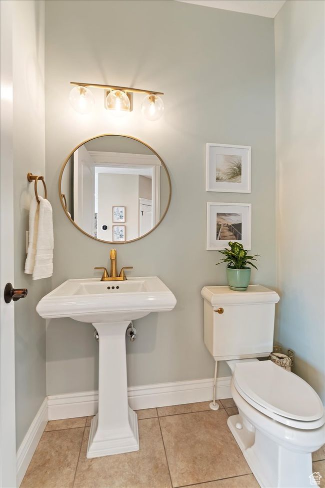 Half bath featuring baseboards, tile patterned flooring, and toilet | Image 45