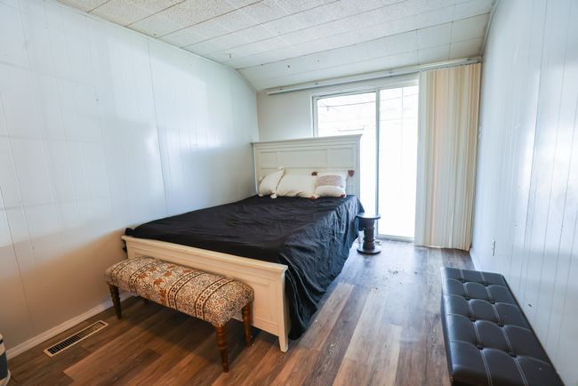 Bedroom featuring visible vents and wood finished floors | Image 15