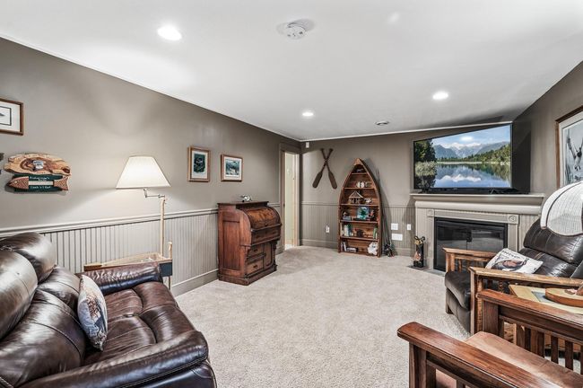 The walk-out lower level offers a spacious family room complete with a cozy fireplace. | Image 20