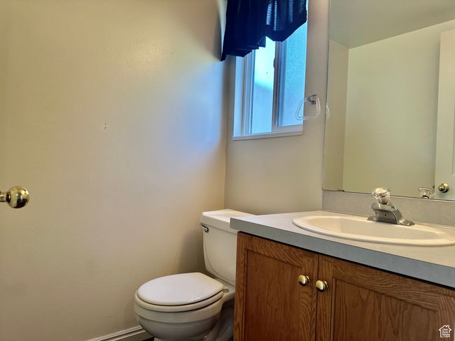 Half Bathroom with toilet and vanity conveniently located off the kitchen | Image 12