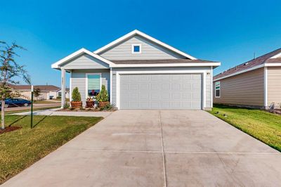 Single story home featuring a garage and a front lawn | Image 1