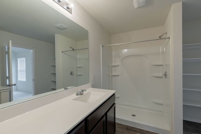 Bathroom featuring wood finished floors, walk in shower, and a textured ceiling | Image 11