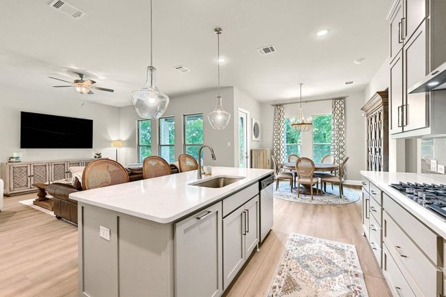 Kitchen with appliances with stainless steel finishes, light wood finished floors, visible vents, and a sink | Image 13
