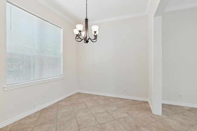 Spare room with a chandelier and ornamental molding | Image 10