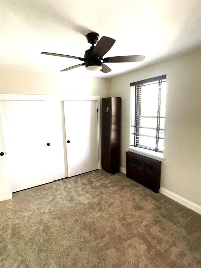 Unfurnished bedroom with carpet floors, ceiling fan, and baseboards | Image 4