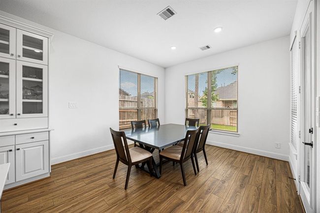 As you enter the kitchen space you will find the breakfast nook surrounded by windows, as well as a exterior door to the outside patio. | Image 27