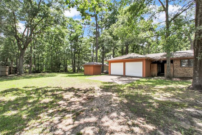 The detached two-car garage and double-wide driveway provide functional charm, while the red brick exterior offers enduring curb appeal. | Image 35