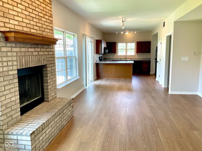 Family room view into eat-in kitchen area and kitchen (new flooring and paint) | Image 17