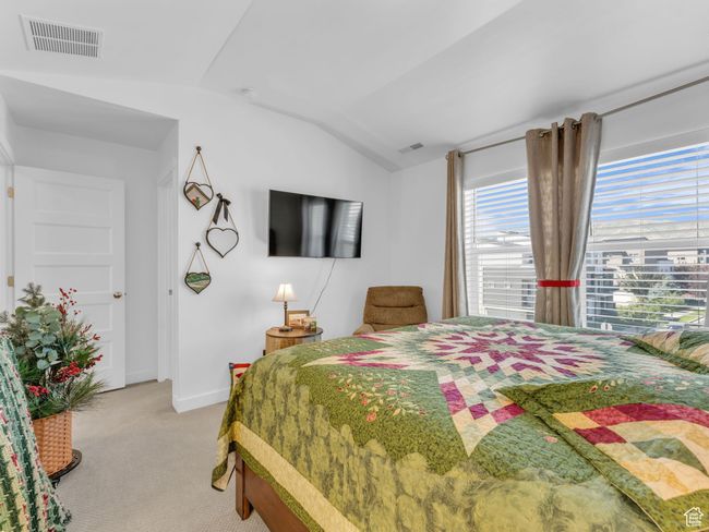 Owners Suite featuring lofted ceiling and light carpet | Image 28