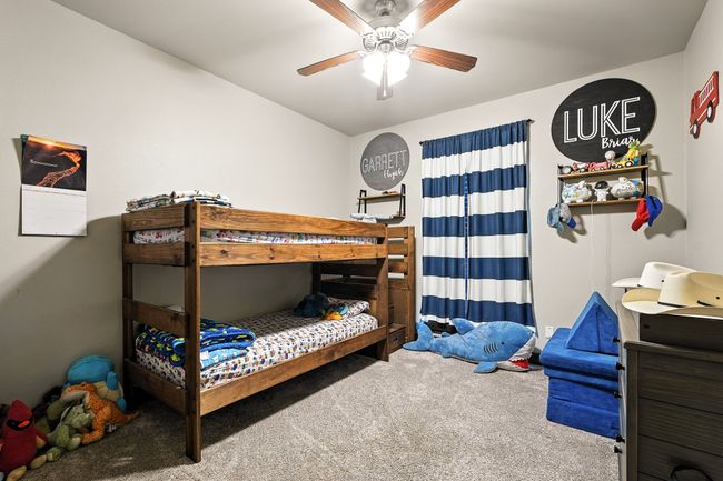 Carpeted bedroom featuring ceiling fan | Image 27