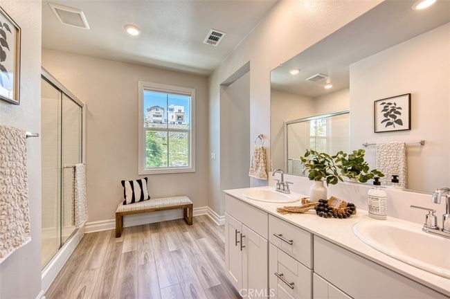Primary bedroom en-suite bathroom with step-in shower and dual sinks. | Image 19