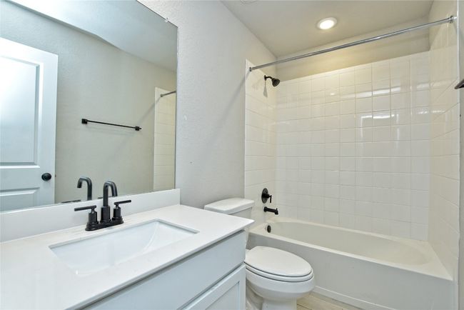 Bathroom featuring vanity, toilet, recessed lighting, and shower / bathtub combination | Image 22