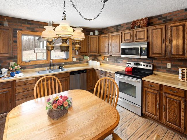 The kitchen is functional and stylish, with classic cabinets you can keep as-is or update to fit your taste. | Image 13
