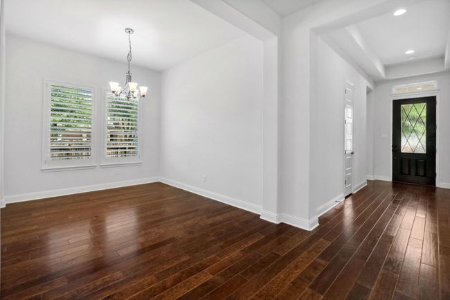 A formal dining room hosts a chandelier and makes the perfect space for holidays and family meals. | Image 4