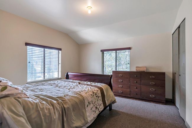 Carpeted bedroom featuring vaulted ceiling | Image 31