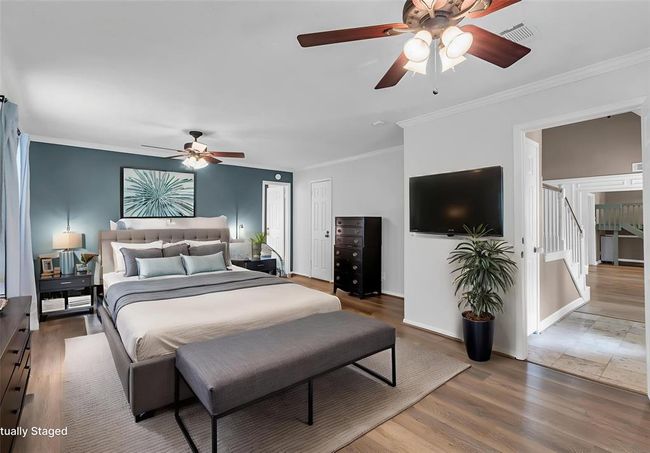 The elegant primary bedroom suite showcases new LVP flooring for a stylish, modern look. | Image 4