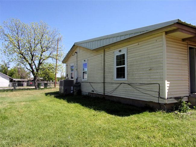 View of property exterior featuring fence and a lawn | Image 6