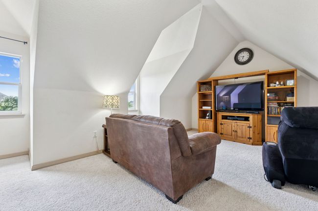 Living area featuring carpet flooring, lofted ceiling, and baseboards | Image 29