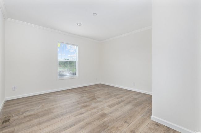 Unfurnished room with crown molding and light wood finished floors | Image 21