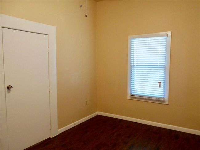 Spare room with baseboards and dark wood-style floors | Image 8