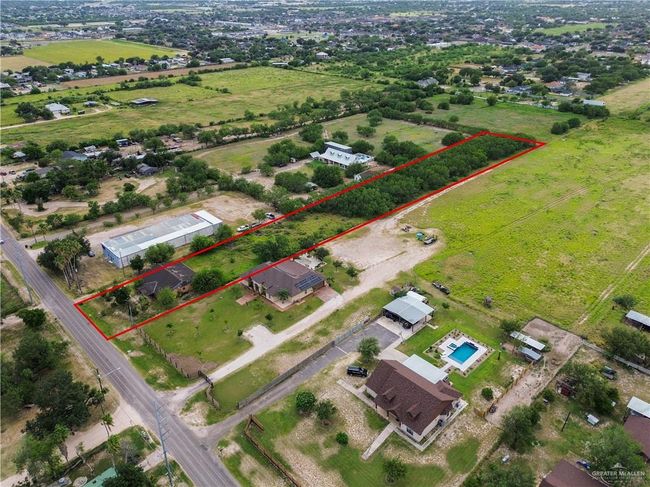 Aerial view of sparsely populated area featuring property parcel outlined | Image 13