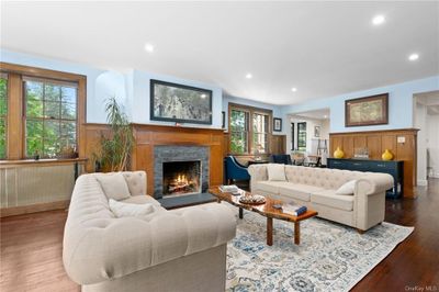 Living room featuring a fireplace and wood-type flooring | Image 3