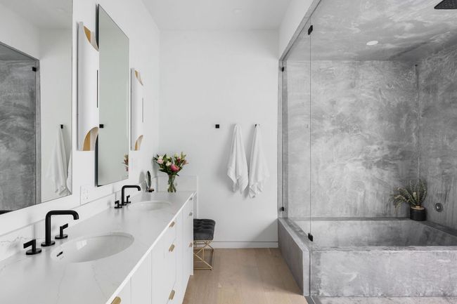 Bathroom featuring a garden tub, wood finished floors, double vanity, baseboards, and an enclosed shower | Image 17