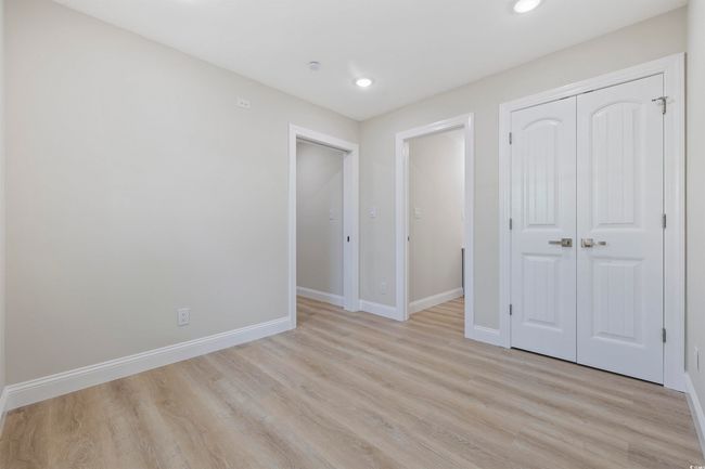 Unfurnished bedroom featuring light wood-type flooring, baseboards, a closet, and recessed lighting | Image 34