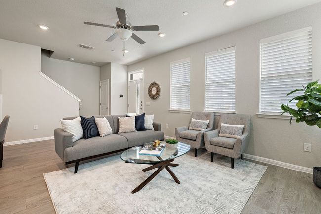 Living area with ceiling fan, and light wood-style floors | Image 5
