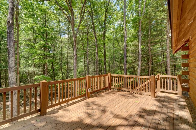 Deck featuring a view of trees | Image 39