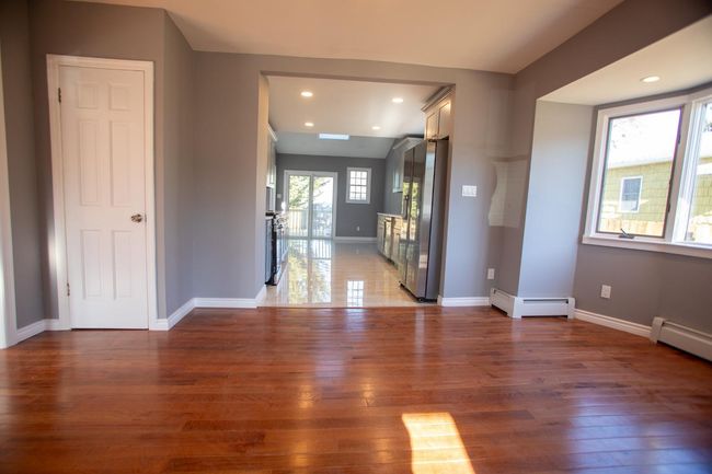 Foyer entrance with dark hardwood / wood-style floors and a baseboard heating unit | Image 6