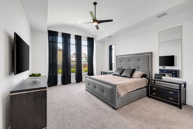 Bedroom with vaulted ceiling, light colored carpet, baseboards, and ceiling fan | Image 17
