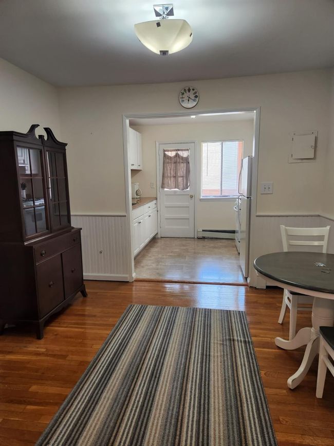 Foyer with wainscoting, a baseboard radiator, and wood finished floors | Image 10