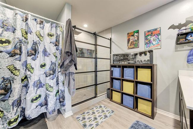 Full bathroom with a shower stall, vanity, wood finished floors, and recessed lighting | Image 25