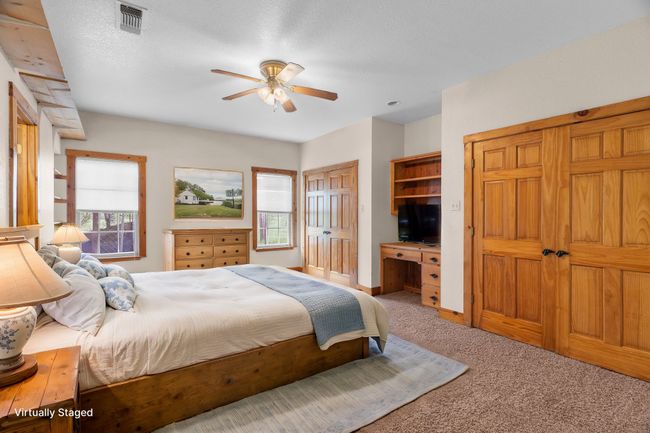 Carpeted bedroom with visible vents, multiple windows, multiple closets, and ceiling fan | Image 23
