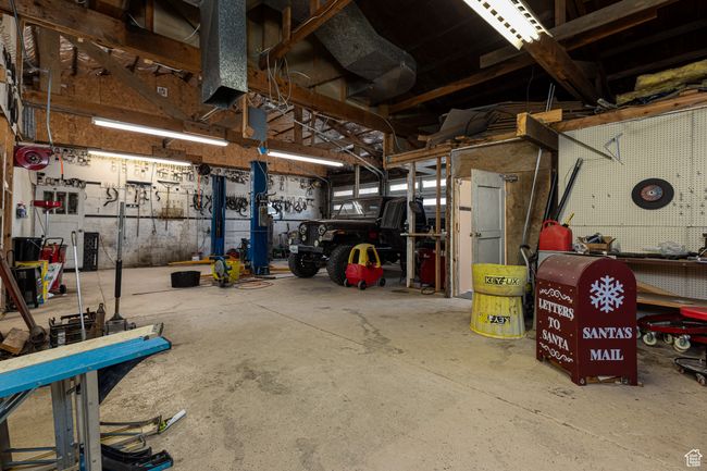 Garage with a workshop area | Image 31