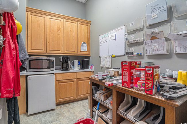 Kitchen featuring stainless steel microwave, refrigerator, and light countertops | Image 9