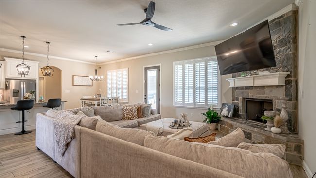 Living area featuring raised ceiling, tile flooring, gas fireplace | Image 4