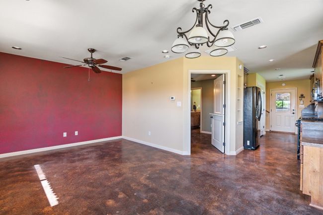 View of guest apartment living room and first floor bedroom/bathroom. | Image 35