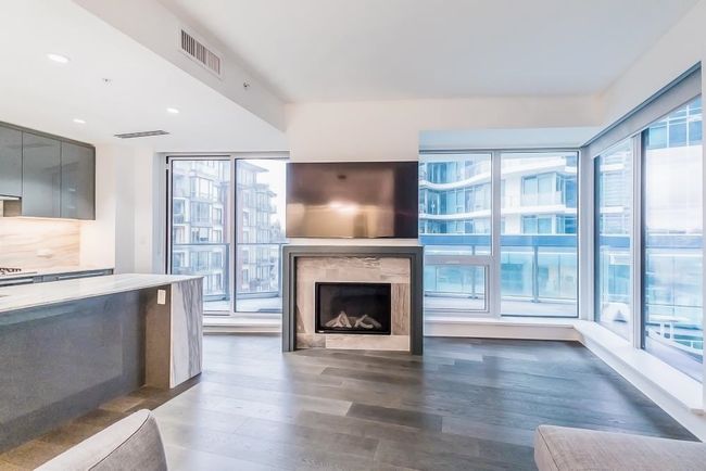 Unfurnished living room featuring recessed lighting, a premium fireplace, wood finished floors, and visible vents | Image 6