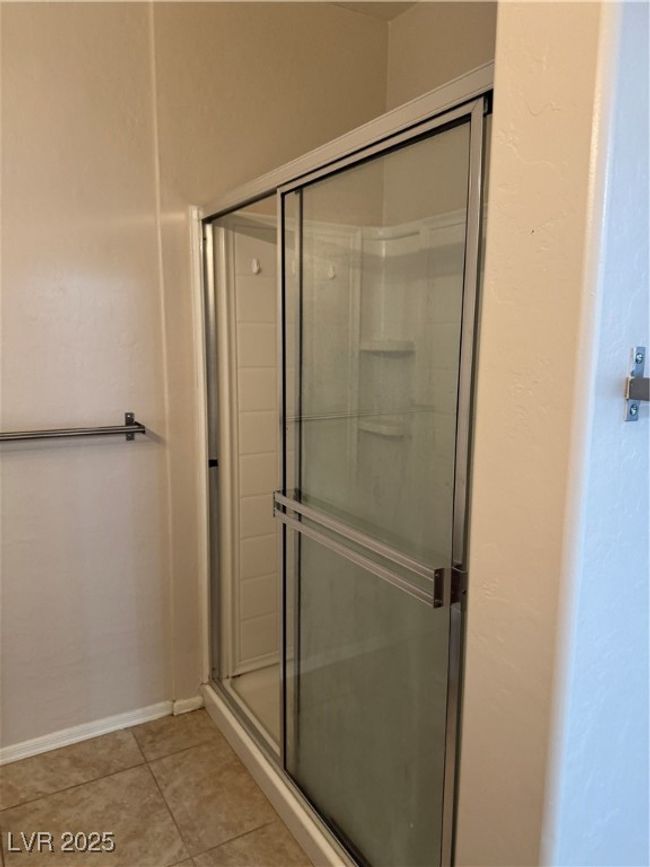Full bath with a shower stall and tile patterned floors | Image 12
