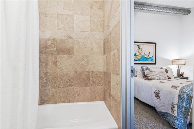 View of 2nd bedroom from the ensuite bathroom with natural stone bath. | Image 20