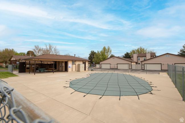 Community pool featuring fence and an outbuilding | Image 23