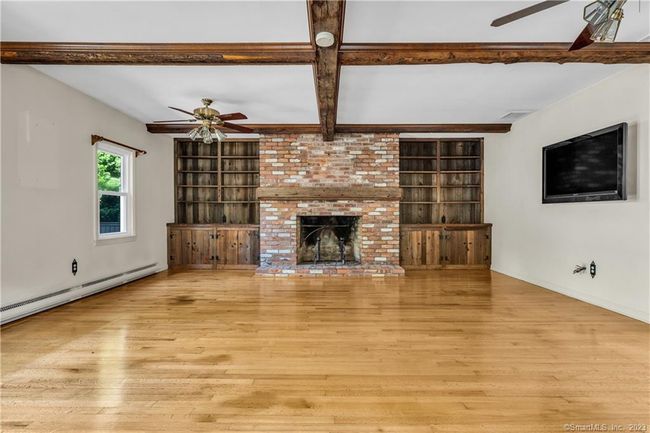 The custom fireplace and built-ins are attractive features. | Image 5