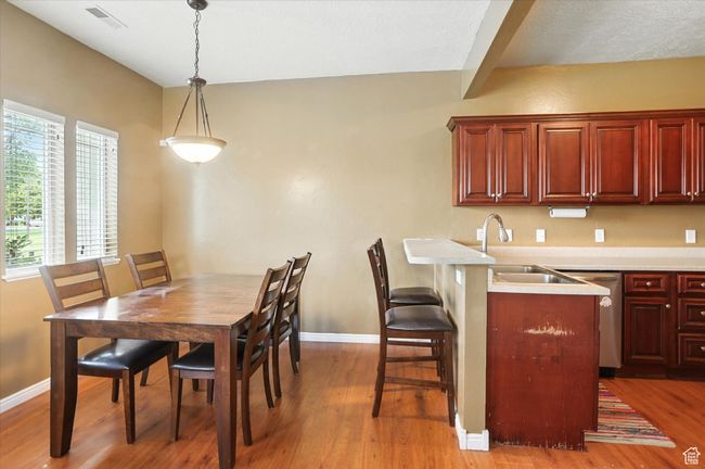 Dining room with light wood-style floors and baseboards | Image 9