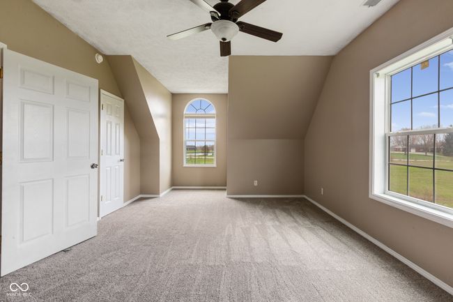bonus room featuring carpet flooring, baseboards, a ceiling fan, and lofted ceiling | Image 16